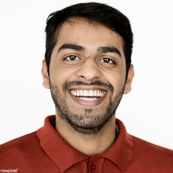 Happy man with a bright smile, wearing a red shirt, in a professional setting.