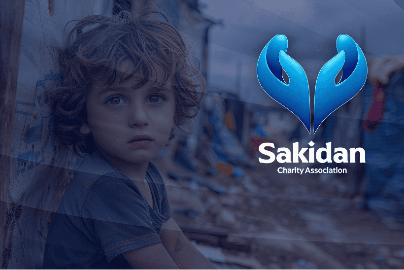 Child in a refugee camp with Sakidan Charity logo in the background.